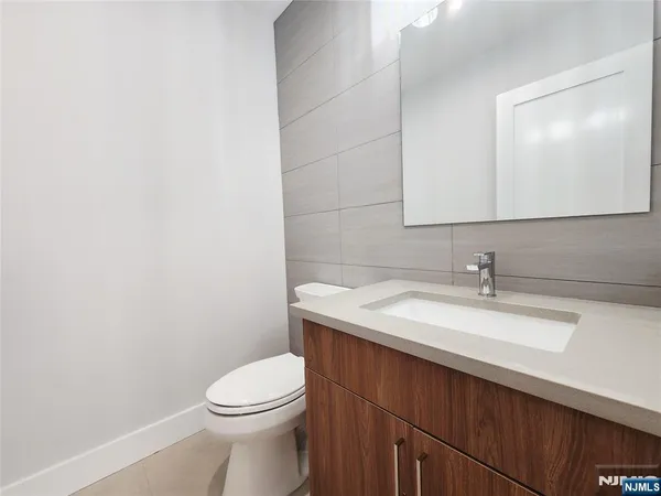 a bathroom with a sink a toilet and mirror