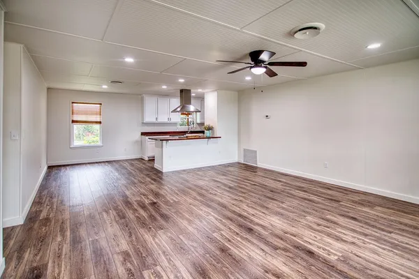 a large kitchen with stainless steel appliances a large island in the center