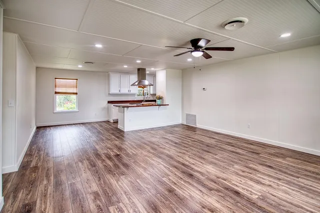 a large kitchen with stainless steel appliances a large island in the center