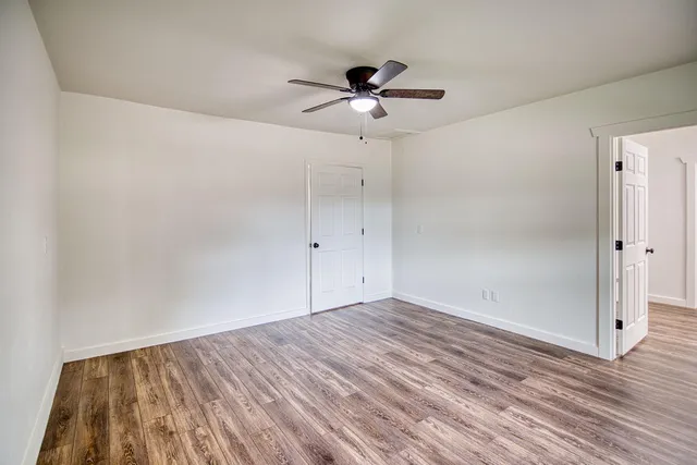 a kitchen with stainless steel appliances granite countertop a sink a stove and a wooden floors