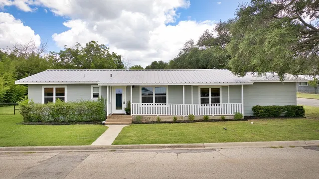 a front view of a house with a garden