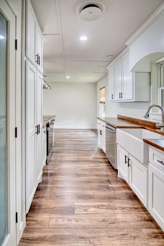 a bathroom with a granite countertop sink a toilet a bathtub and mirror