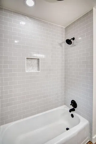 a bathroom with a toilet and a mirror