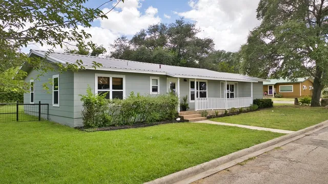 a front view of a house with a yard and porch