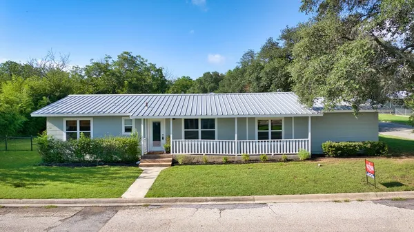 a view of a city with lush green forest