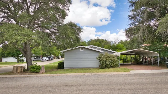 a view of street along with house and trees