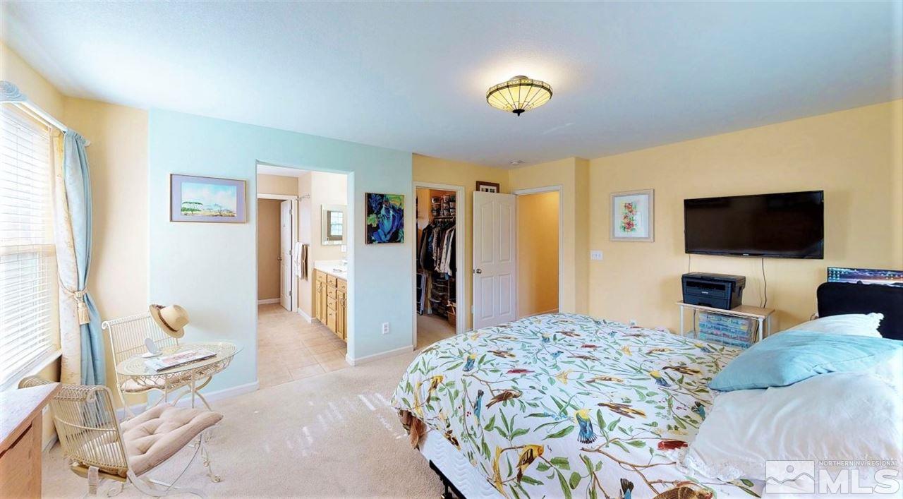 11210 Messina Way Reno, NV 89521 - Photo 16 of 29 a bedroom with a bed and a television