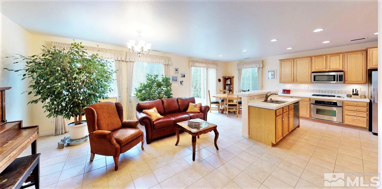 11210 Messina Way Reno, NV 89521 - Photo 4 of 29 a living room with furniture wooden floor and a kitchen view