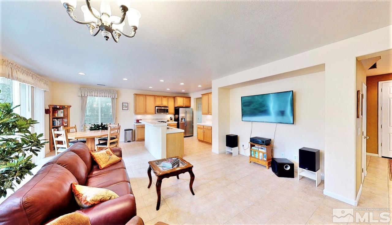 11210 Messina Way Reno, NV 89521 - Photo 8 of 29 a living room with furniture and a flat screen tv