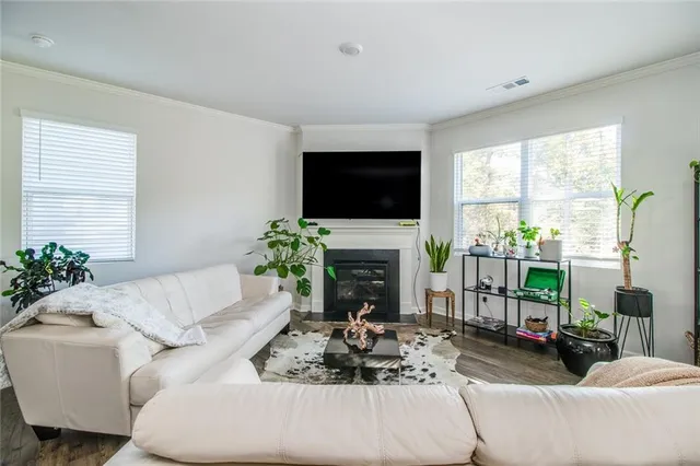 a living room with furniture and kitchen view