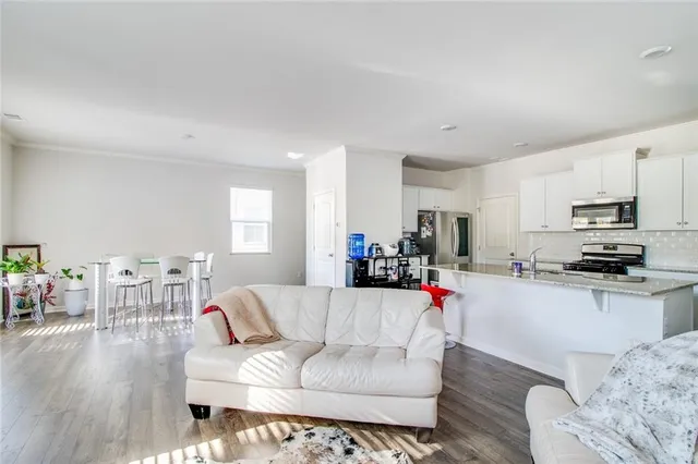 a bedroom with a bed and painting on the wall