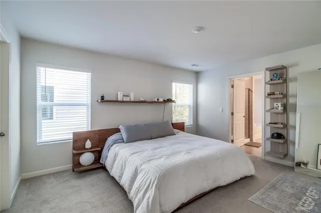 a view of a hallway with bathroom and front door