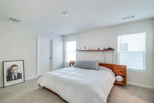 a bedroom with a bed and window