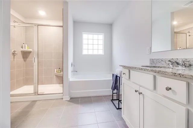 a view of the house with a big yard and large tree