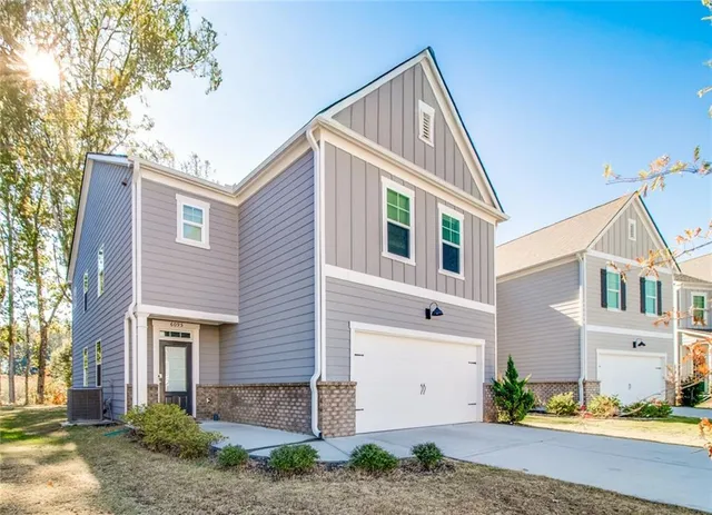 a view of a brick house with a yard