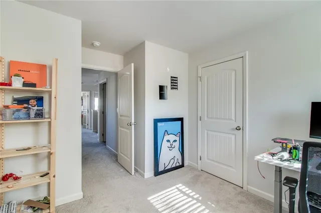 a view of a brick house with many windows next to a yard