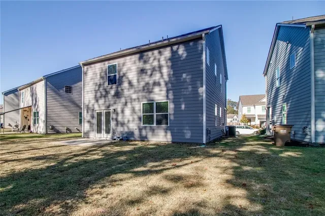 a view of a big yard with table and chairs under an umbrella