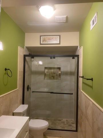 1624 Longmont Drive Lawrenceville, GA 30044 - Photo 13 of 17 a bathroom with a toilet and a shower