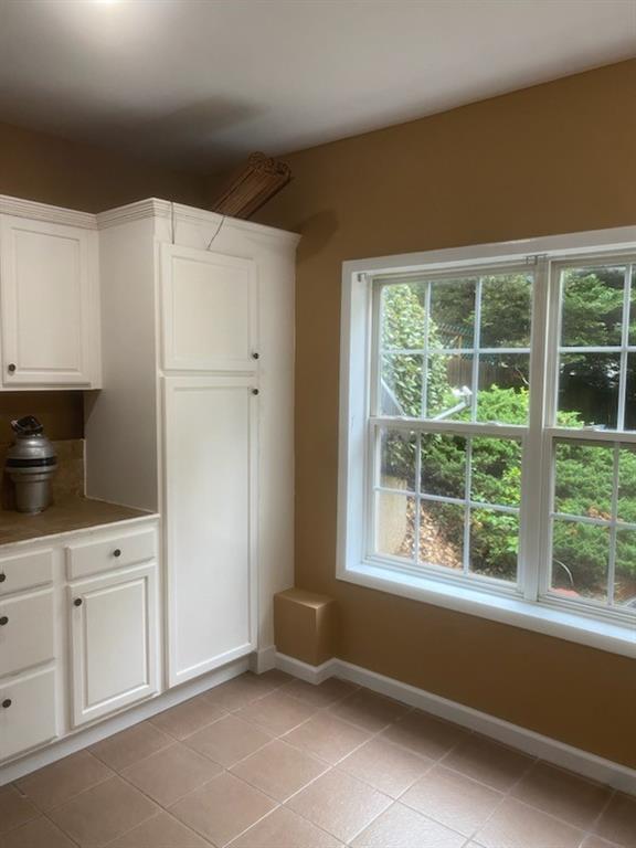 1624 Longmont Drive Lawrenceville, GA 30044 - Photo 5 of 17 a kitchen with white cabinets and window