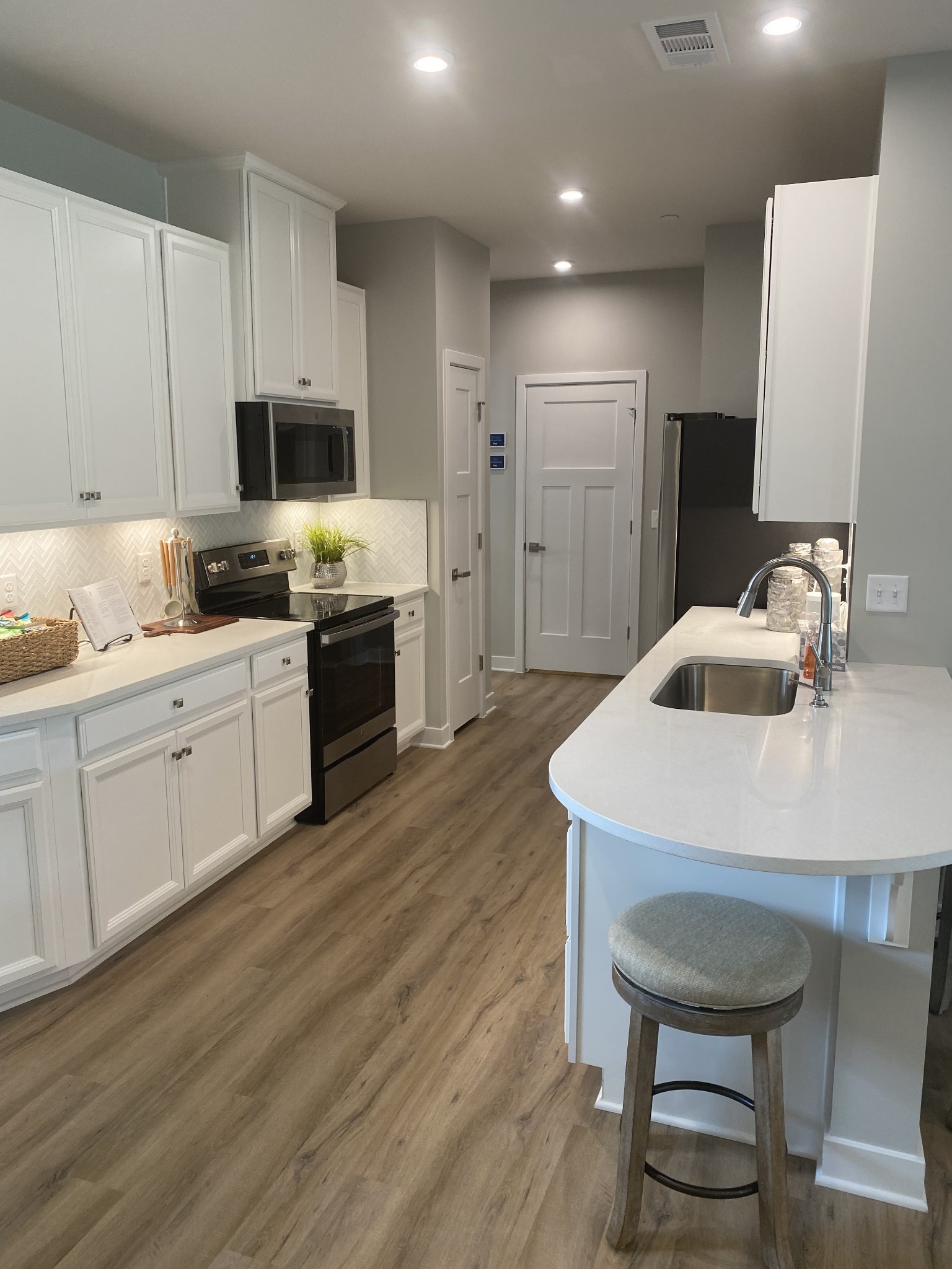 101 Keelon Gap Road, Unit 180D Spring Hill, TN 37174 - Photo 3 of 13 a kitchen with sink cabinets and wooden floor