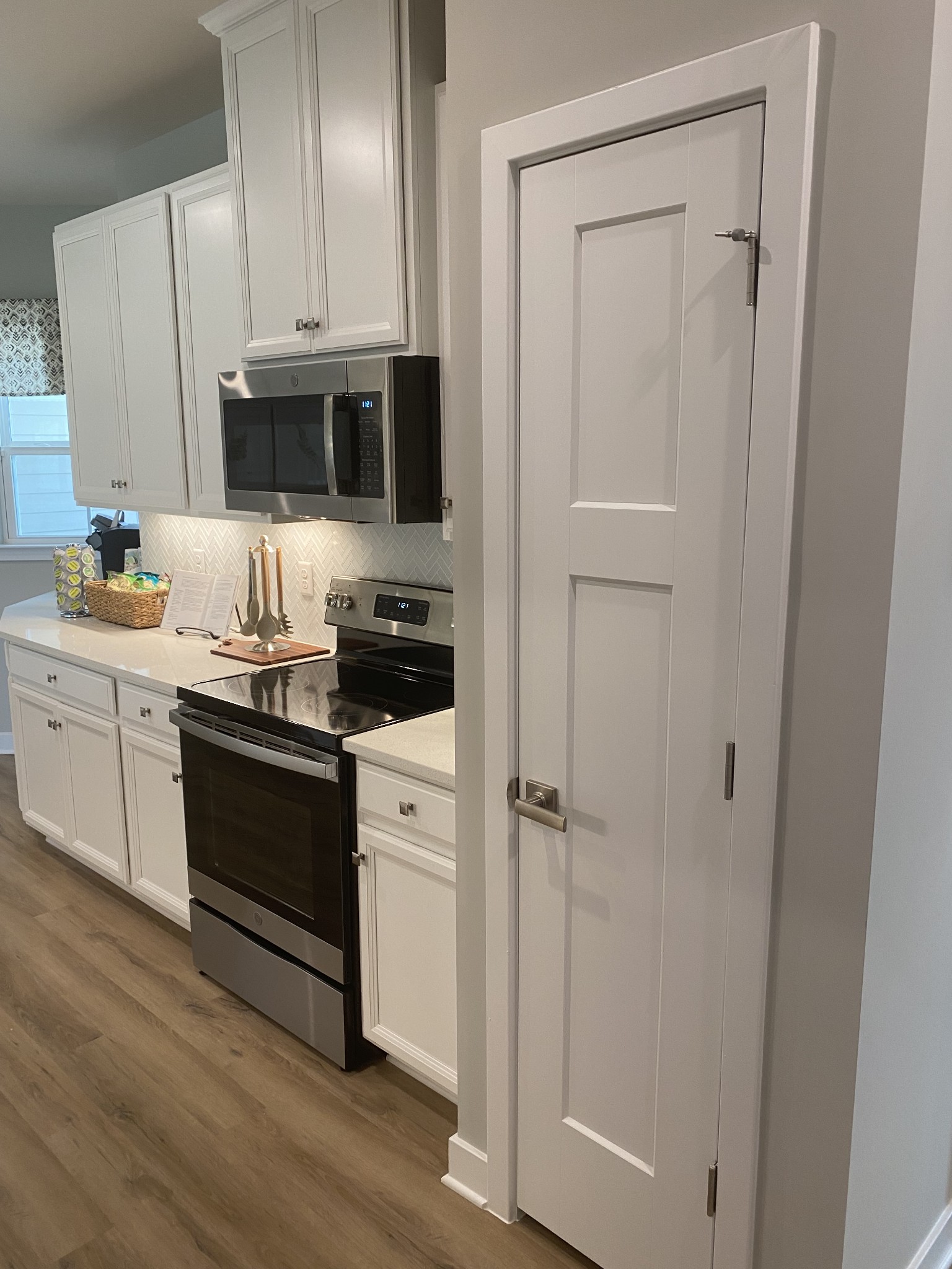101 Keelon Gap Road, Unit 180D Spring Hill, TN 37174 - Photo 4 of 13 a kitchen with stainless steel appliances a refrigerator sink and white cabinets