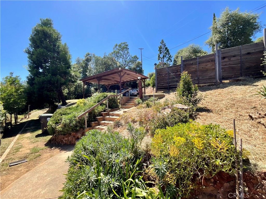 7282 Marin Street Nice, CA 95464 - Photo 43 of 69 a view of a backyard with chair and potted plants