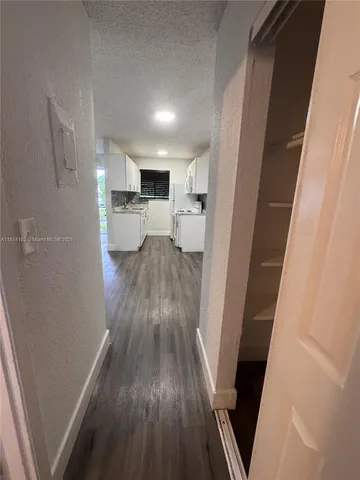 a view of a kitchen from a hallway