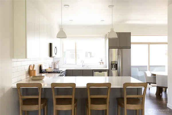 a view of a kitchen with granite countertop dining room and wooden floor