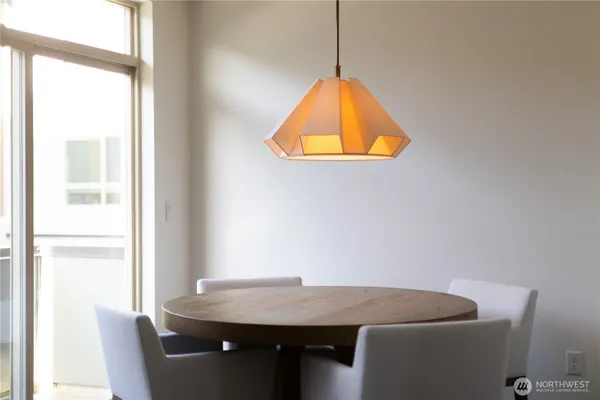 a view of a kitchen counter space with wooden floor and chair