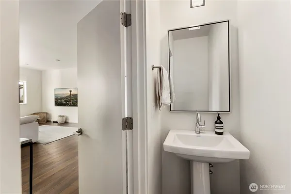 a bedroom with a bed and a large mirror next to a window