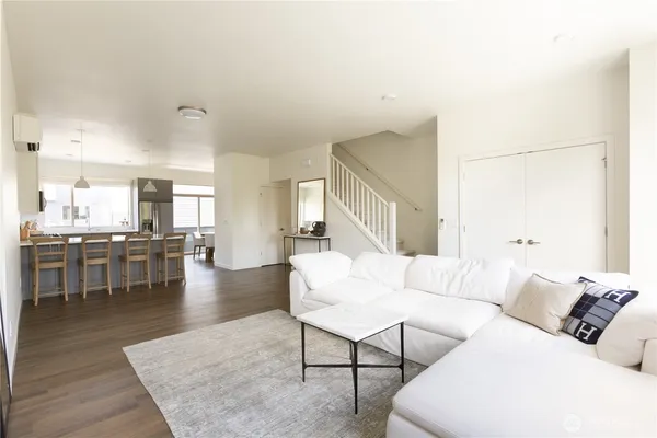 a view of a livingroom with furniture and hardwood floor