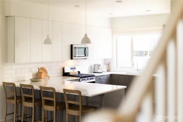 a kitchen with stainless steel appliances a sink stove and refrigerator