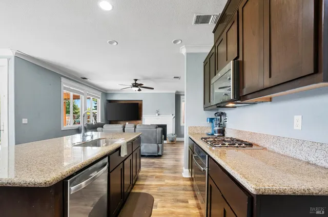 a kitchen with a sink stove and cabinets