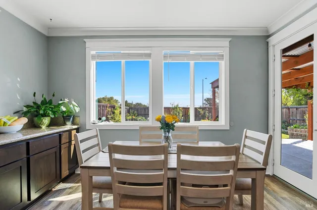 a view of a dining room with furniture and a potted plant