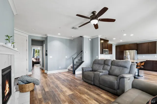 a living room with furniture and a wooden floor