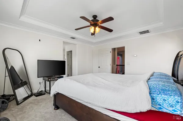 a bedroom with a bed and flat screen tv