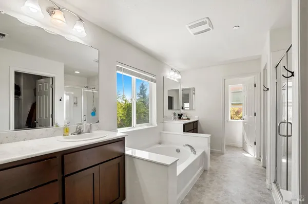 a bathroom with a tub sink and mirror