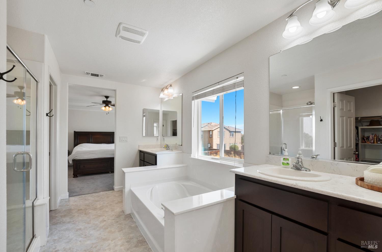 5311 Gramercy Circle Fairfield, CA 94533 - Photo 27 of 43 a en suite bathroom with a double vanity sink a mirror and a shower