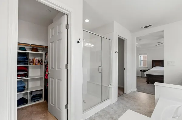 a view of a bathroom with a tub and shower