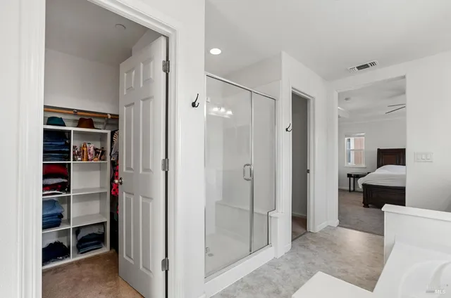 a view of a bathroom with a tub and shower
