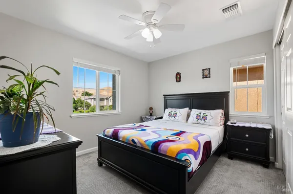 a bedroom with a bed and a potted plant