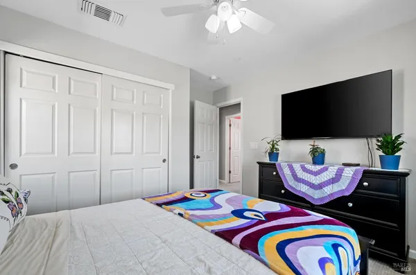 a bedroom with a bed and a flat screen tv