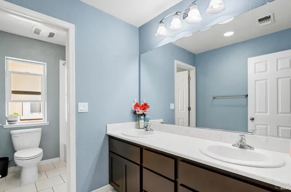 a bathroom with a sink double vanity and a mirror