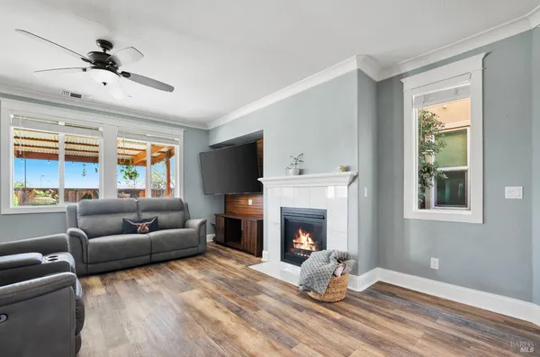 a living room with furniture a flat screen tv and a fireplace
