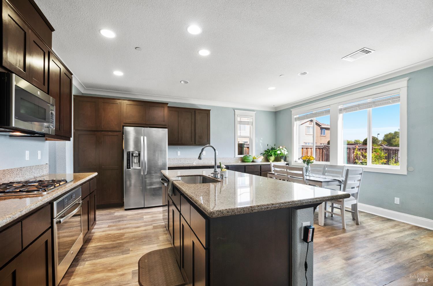5311 Gramercy Circle Fairfield, CA 94533 - Photo 8 of 43 a kitchen with kitchen island granite countertop a sink stove and refrigerator