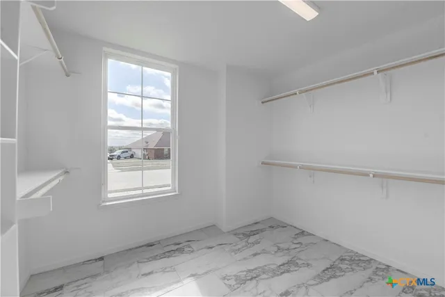 a kitchen with granite countertop a sink and dishwasher a stove with wooden floors