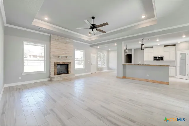 a view of an empty room with a kitchen and a kitchen