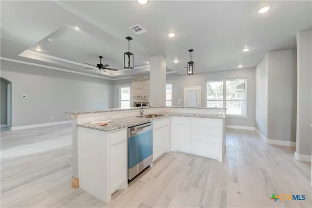 wooden floor in an empty room with a ceiling fan