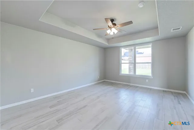 a spacious bathroom with a tub sink and mirror