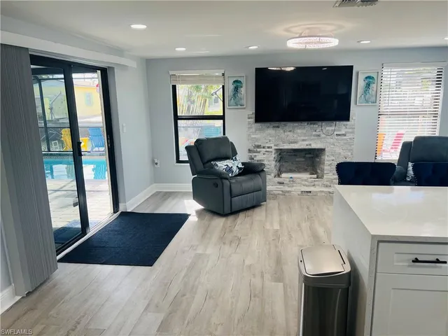 a living room with fireplace furniture and a flat screen tv